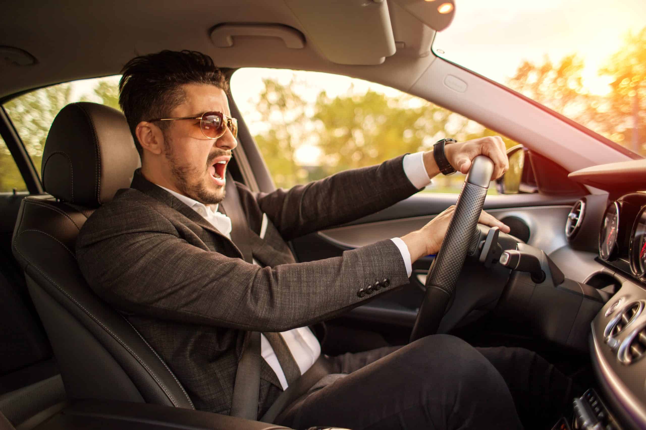 Angry business man driving and honking