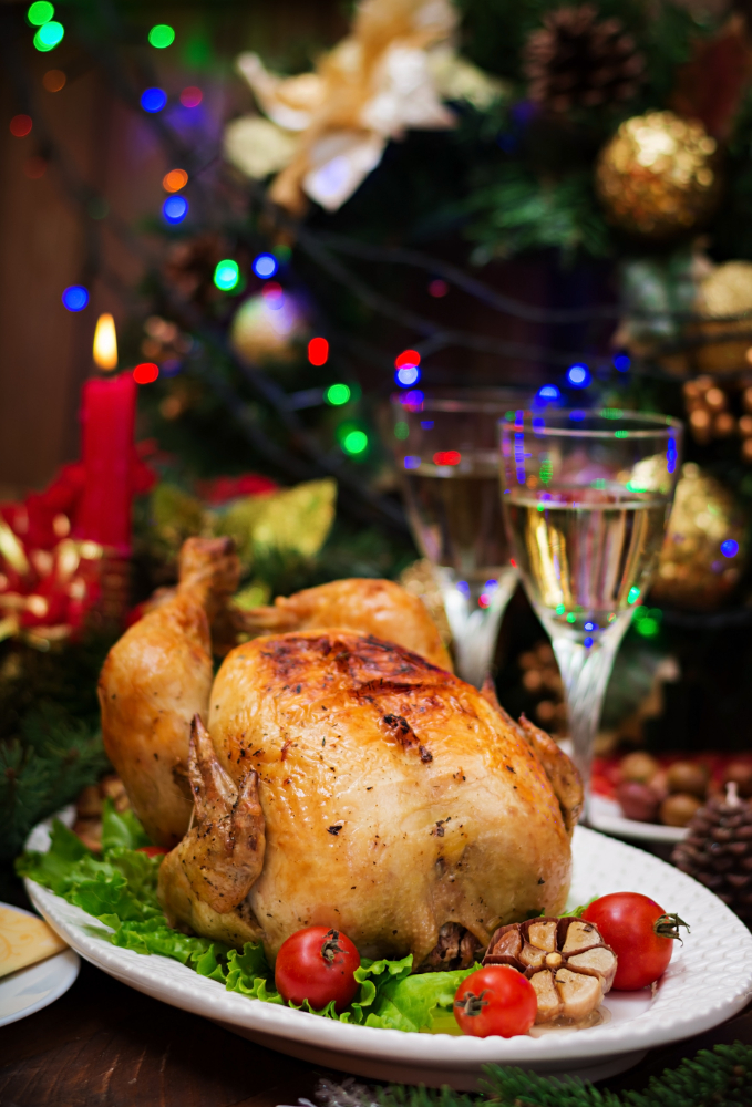 christmas-table-served-with-a-turkey-decorated-with-bright-tinsel-and-candles