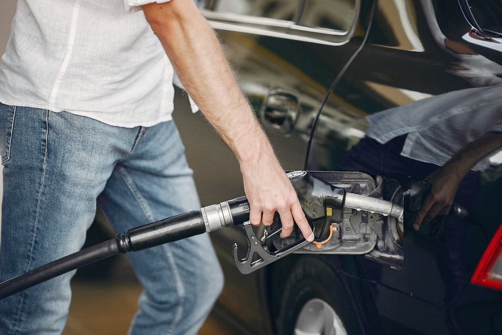 handsome-man-pours-gasoline-into-tank-of-car