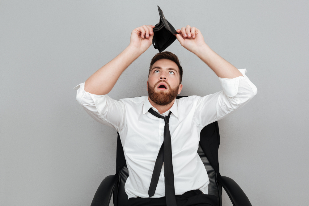 frustrated-surprised-bearded-man-in-white-shirt-showing-empty-wallet