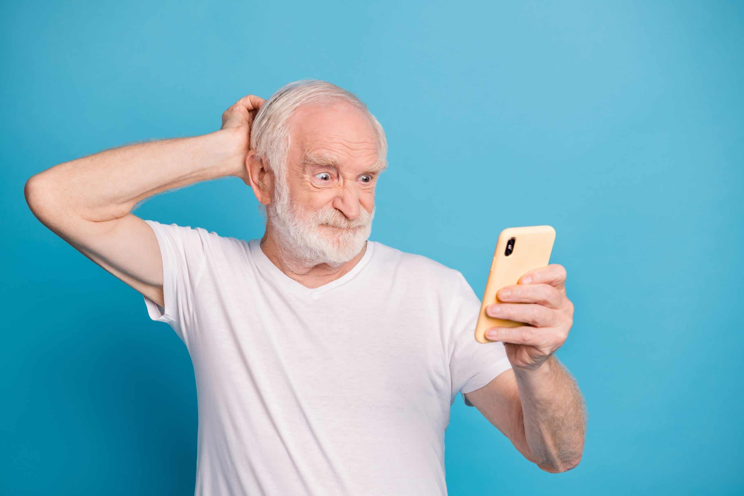 Portrait of unsatisfied person hand behind head staring phone grimace bad mood isolated on blue color background.