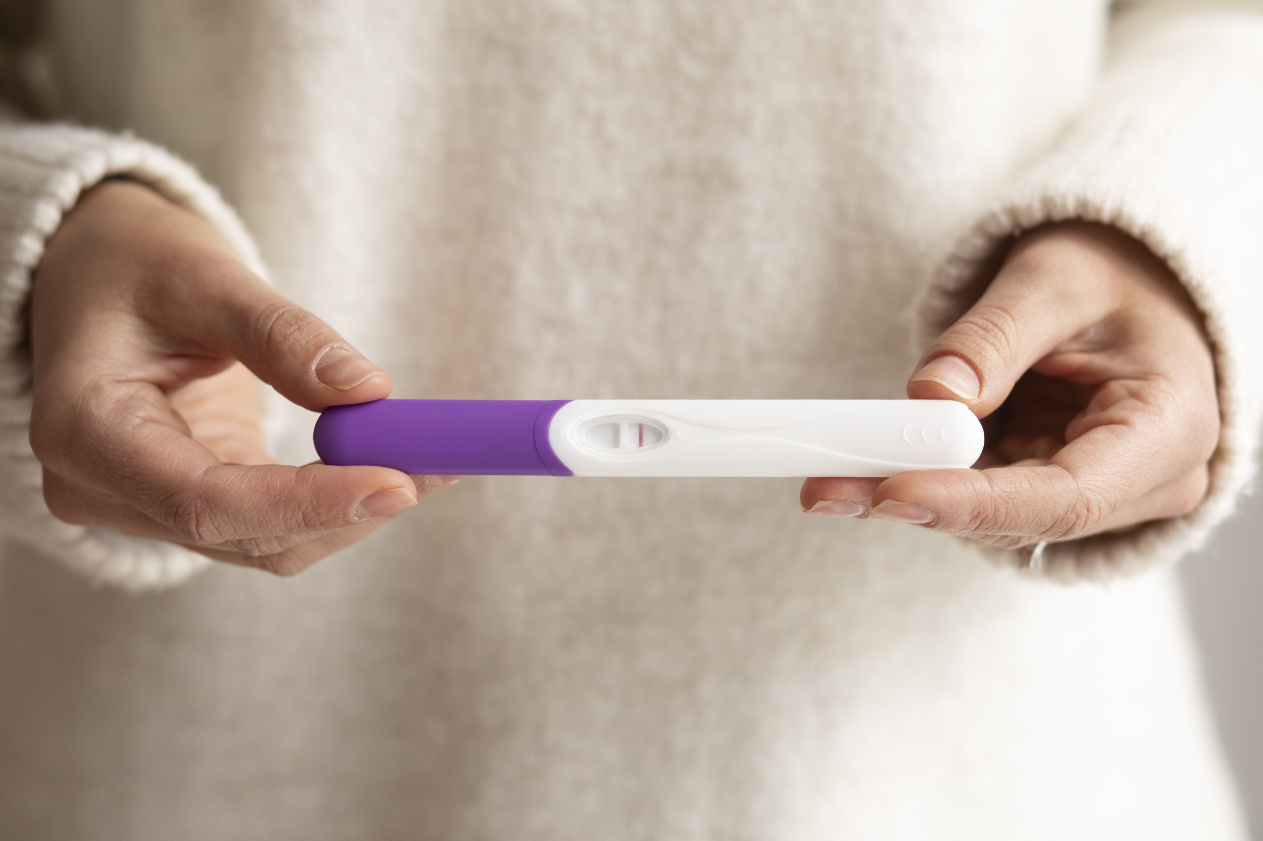 close-up-hands-holding-pregnancy-test