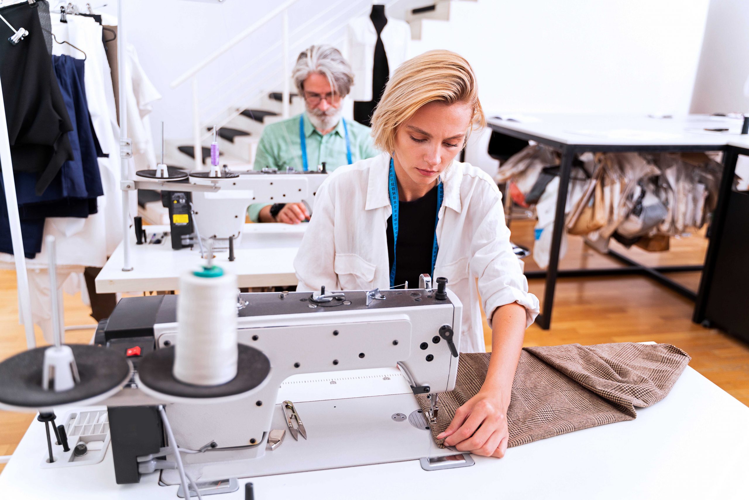 Multiethnic team of fashion designers working in a clothing start-up workshop - Multiracial group of stylists, tailor designers and dressmakers working on a new collection